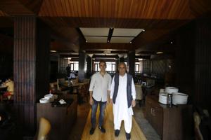 The peaceful, timeless ambience of the three-storey hotel belies the storms it has braved. ‘There was a time in the 1990s when we had to travel with the Army-protected journalists to pick up groceries,’ says Ghulam Hassan, 72, a second generation owner. His son Hayat Bhat (left) is now managing director.(Waseem Andrabi/HT Photo) The peaceful, timeless ambience of the three-storey hotel belies the storms it has braved. ‘There was a time in the 1990s when we had to travel with the Army-protected journalists to pick up groceries,’ says Ghulam Hassan, 72, a second generation owner. His son Hayat Bhat (left) is now managing director.(Waseem Andrabi/HT Photo)