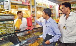 Municipal officials conduct a check-up at a sweet mart in Nigdi on Monday.(HT Photo) Municipal officials conduct a check-up at a sweet mart in Nigdi on Monday.(HT Photo)