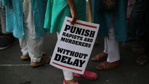 A protestor stands with a placard during a protest against two recently reported rape cases as they gather near the parliament in New Delhi.(AP File Photo) A protestor stands with a placard during a protest against two recently reported rape cases as they gather near the parliament in New Delhi.(AP File Photo)