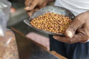 An employee holds a scoop of chickpeas in a store at a local market in Hyderabad, India.(Dhiraj Singh/Bloomberg) An employee holds a scoop of chickpeas in a store at a local market in Hyderabad, India.(Dhiraj Singh/Bloomberg)