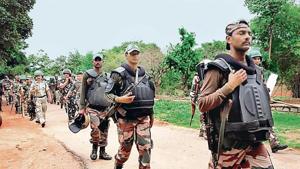 Security personnel deployed to arrest the Khunti gangrape accused patrol in Udbhuru village on June 26.(HT Photo)