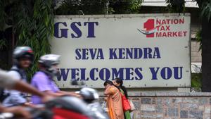 A motorist rides past a GST Seva Kendra board outside the Central tax building, in Bengaluru on Thursday.(PTI Photo) A motorist rides past a GST Seva Kendra board outside the Central tax building, in Bengaluru on Thursday.(PTI Photo)