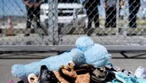 (FILES) This June 21, 2018 file photo shows security personal standing before shoes and toys left at the Tornillo Port of Entry in Tornillo, Texas.(AFP) (FILES) This June 21, 2018 file photo shows security personal standing before shoes and toys left at the Tornillo Port of Entry in Tornillo, Texas.(AFP)