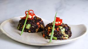 Organic aromatic Himalayan black rice tossed with vegetables and cottage cheese in Chinese style. Organic aromatic Himalayan black rice tossed with vegetables and cottage cheese in Chinese style.