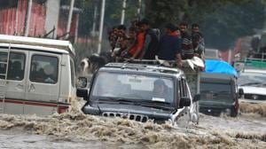 Vehicles wade through a flooded road after heavy rainfall in Srinagar on June 30.(Waseem Andrabi/HT Photo)
