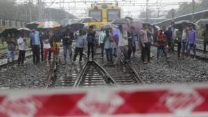 Commuters watch rescuers work at the site of a pedestrian bridge that collapsed at a train station in Mumbai on July 3, 2018. Part of a pedestrian bridge at a Mumbai train station collapsed Tuesday morning during heavy rains.(AP) Commuters watch rescuers work at the site of a pedestrian bridge that collapsed at a train station in Mumbai on July 3, 2018. Part of a pedestrian bridge at a Mumbai train station collapsed Tuesday morning during heavy rains.(AP)