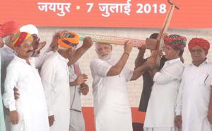 Prime Minister Narendra Modi being presented a plough from farmers as he meets beneficiaries of governemnt schemes at Amrudon Ka Bagh in Jaipur.(HT File Photo) Prime Minister Narendra Modi being presented a plough from farmers as he meets beneficiaries of governemnt schemes at Amrudon Ka Bagh in Jaipur.(HT File Photo)