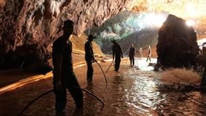 In this undated photo released by Royal Thai Navy on July 7, 2018, Thai rescue teams arrange water pumping system at the entrance to a flooded cave complex where 12 boys and their soccer coach have been trapped since June 23, in Mae Sai, Chiang Rai province, northern Thailand.(Royal Thai Navy via AP)
