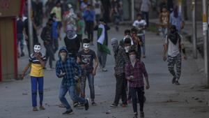 Protesters hold bricks and rocks to throw at policemen during a protest in Srinagar on Saturday.(AP Photo) Protesters hold bricks and rocks to throw at policemen during a protest in Srinagar on Saturday.(AP Photo)