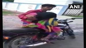 Man takes dead body of mother on a motorcycle for post mortem after being allegedly denied hearse van by district hospital in Mohangarh.(ANI Photo) Man takes dead body of mother on a motorcycle for post mortem after being allegedly denied hearse van by district hospital in Mohangarh.(ANI Photo)