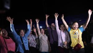 Volunteers celebrate at a makeshift press centre in Mae Sai district of Chiang Rai province on July 10, 2018, after the twelve boys and their football coach were rescued.(AFP/Ye Aung THU) Volunteers celebrate at a makeshift press centre in Mae Sai district of Chiang Rai province on July 10, 2018, after the twelve boys and their football coach were rescued.(AFP/Ye Aung THU)