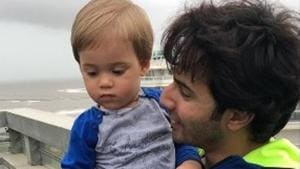 Karan Johar’s son Yash Johar in the arms of Varun Dhawan. Karan Johar’s son Yash Johar in the arms of Varun Dhawan.