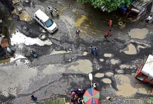 Potholes at Pratiksha Nagar in Sion shot last week.(Vijayanand Gupta/HT Photo)