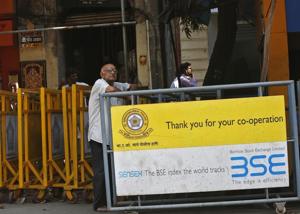 A man looks at a screen across the road displaying the Sensex on the facade of the Bombay Stock Exchange (BSE) building in Mumbai. The IMF praised India for its overall economic management on both domestic and external fronts.(REUTERS) A man looks at a screen across the road displaying the Sensex on the facade of the Bombay Stock Exchange (BSE) building in Mumbai. The IMF praised India for its overall economic management on both domestic and external fronts.(REUTERS)