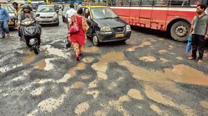 Potholes outside the police commissioner’s office at Crawford Market.(Kunal Patil/HT Photo)