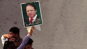 A supporter of the Pakistan Muslim League - Nawaz (PML-N) holds a portrait as he march towards the airport with others to see ousted prime pinister Nawaz Sharif and his daughter Maryam, in Lahore.(Reuters File Photo) A supporter of the Pakistan Muslim League - Nawaz (PML-N) holds a portrait as he march towards the airport with others to see ousted prime pinister Nawaz Sharif and his daughter Maryam, in Lahore.(Reuters File Photo)