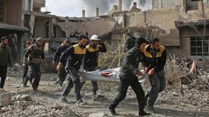 Members of Syrian civil defence forces known as White Helmets evacuate a victim of an air strike in the rebel-held enclave of Hazeh in the Eastern Ghouta near Damascus on February 8, 2018.(AFP File Photo) Members of Syrian civil defence forces known as White Helmets evacuate a victim of an air strike in the rebel-held enclave of Hazeh in the Eastern Ghouta near Damascus on February 8, 2018.(AFP File Photo)