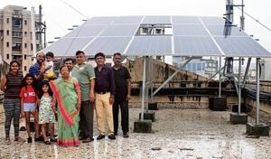 Residents of Arihant Darshan CHS stand beside their 11.05kWp rooftop solar plant.(HT Photo) Residents of Arihant Darshan CHS stand beside their 11.05kWp rooftop solar plant.(HT Photo)
