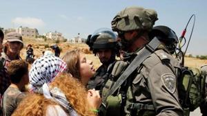 (FILES) This file photo taken on May 12, 2017 shows 17-year-old Ahed Tamimi (C) protesting before Israeli forces in the West Bank village of Nabi Saleh, north of Ramallah.(AFP) (FILES) This file photo taken on May 12, 2017 shows 17-year-old Ahed Tamimi (C) protesting before Israeli forces in the West Bank village of Nabi Saleh, north of Ramallah.(AFP)