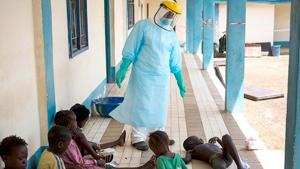 A health official dressed in protective gear examines children suffering from the Ebola virus.(AP file photo) A health official dressed in protective gear examines children suffering from the Ebola virus.(AP file photo)