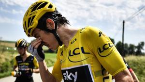 Geraint Thomas cleans his eyes after tear gas was used during a farmers' protest who attempted to block the stage's route at the Tour de France.(AFP) Geraint Thomas cleans his eyes after tear gas was used during a farmers' protest who attempted to block the stage's route at the Tour de France.(AFP)
