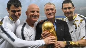 France's coach Didier Deschamps (2R) and France's assistant coach Guy Stephan (2L) pose with the World Cup trophy.(AFP) France's coach Didier Deschamps (2R) and France's assistant coach Guy Stephan (2L) pose with the World Cup trophy.(AFP)