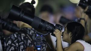 A girl peeks inside the viewfinder of a camera to see a lunar eclipse at a park in Manila, Philippines in January earlier this year.(AP Photo) A girl peeks inside the viewfinder of a camera to see a lunar eclipse at a park in Manila, Philippines in January earlier this year.(AP Photo)