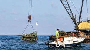Three km off the coast of the city of Sidon, a huge crane on the back of a ship manoeuvred the military hardware into place over the water before dropping them down to the seabed one after the other.(AFP) Three km off the coast of the city of Sidon, a huge crane on the back of a ship manoeuvred the military hardware into place over the water before dropping them down to the seabed one after the other.(AFP)