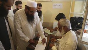 Hafiz Saeed, center, head of the Pakistani religious party Jamaat-ud-Dawa, affixes his thumb impression before casting a vote in Lahore, Pakistan, Wednesday, July 25, 2018.(AP File Photo) Hafiz Saeed, center, head of the Pakistani religious party Jamaat-ud-Dawa, affixes his thumb impression before casting a vote in Lahore, Pakistan, Wednesday, July 25, 2018.(AP File Photo)
