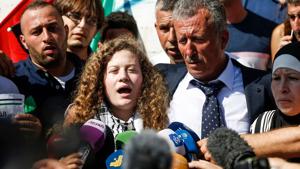 Palestinian activist and campaigner Ahed Tamimi speaks to reporters upon her release from prison after an eight-month sentence for slapping two Israeli soldiers, on the outskirts of the West Bank village of Nabi Saleh on July 29, 2018, as she is accompanied by her father and mother.(AFP) Palestinian activist and campaigner Ahed Tamimi speaks to reporters upon her release from prison after an eight-month sentence for slapping two Israeli soldiers, on the outskirts of the West Bank village of Nabi Saleh on July 29, 2018, as she is accompanied by her father and mother.(AFP)