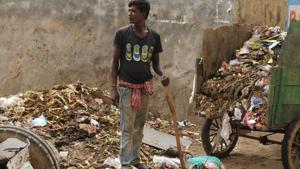 A sanitation worker is seen working without gloves, boots, or mask in Sector 52, Wazirabad village of Gurugram.(Parveen Kumar/ HT Photo) A sanitation worker is seen working without gloves, boots, or mask in Sector 52, Wazirabad village of Gurugram.(Parveen Kumar/ HT Photo)