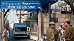 Policemen stand guard as an ambulance leaves the main entrance of Tihar Jail in New Delhi.(AFP) Policemen stand guard as an ambulance leaves the main entrance of Tihar Jail in New Delhi.(AFP)