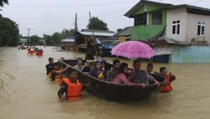 Members of Myanmar Rescue Team carry residents in a boat to travel along a flooded road in Bago, about 80 kilometers (50 miles) northeast of Yangon, Myanmar on July 29, 2018.(AP Photo) Members of Myanmar Rescue Team carry residents in a boat to travel along a flooded road in Bago, about 80 kilometers (50 miles) northeast of Yangon, Myanmar on July 29, 2018.(AP Photo)