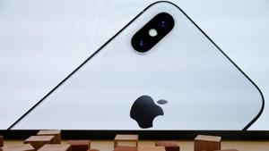 An iPhone X is seen on a large video screen in the new Apple Visitor Center in Cupertino, California.(Reuters) An iPhone X is seen on a large video screen in the new Apple Visitor Center in Cupertino, California.(Reuters)