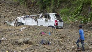 A boy walks past a car that was washed away after the area was lashed by incessant rains and flood situation, in Haldwani on July 31.(File/PTI) A boy walks past a car that was washed away after the area was lashed by incessant rains and flood situation, in Haldwani on July 31.(File/PTI)