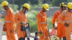National Disaster Response Force (NDRF) rescue workers at a building collapse site in Greater Noida. A three-storey building collapsed in Kerala’s Palakkad, seven people have been rescued so far while feared trapped under debris.(Representative Image/HT Photo) National Disaster Response Force (NDRF) rescue workers at a building collapse site in Greater Noida. A three-storey building collapsed in Kerala’s Palakkad, seven people have been rescued so far while feared trapped under debris.(Representative Image/HT Photo)