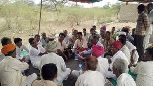 Villagers sit on a dharna outside a liquor shop at Mithdau village in Barmer.(HT Photo) Villagers sit on a dharna outside a liquor shop at Mithdau village in Barmer.(HT Photo)