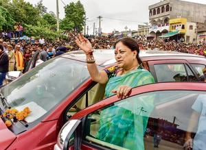 Rajasthan chief minister Vasundhara Raje waves during the 'Rajasthan Gaurav Yatra' at Gogunda near Udaipur on Sunday. Since she became the chief minister for the first time in 2003, Raje has always started her election campaign from the Charbhuja temple in Rajsamand, one of the six districts in Udaipur division that constitute the Mewar region.(PTI Photo)