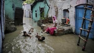 Boys play in flood waters outside their submerged home by the banks of the Yamuna in New Delhi, India, July 31, 2018(AP) Boys play in flood waters outside their submerged home by the banks of the Yamuna in New Delhi, India, July 31, 2018(AP)