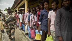People stand in a queue to check if their names are included in the National Register of Citizens at a draft centre in Bur Gaon village in Assam on July 30.(AP Photo) People stand in a queue to check if their names are included in the National Register of Citizens at a draft centre in Bur Gaon village in Assam on July 30.(AP Photo)
