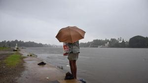 A man near River Periyar in Kochi in 2018. Heavy rains lashed several parts of Kerala on Wednesday, leading to copious inflows into reservoirs and sounding of a red alert at Idamalayar dam in Ernakulam district.(Representative Image/AP Photo) A man near River Periyar in Kochi in 2018. Heavy rains lashed several parts of Kerala on Wednesday, leading to copious inflows into reservoirs and sounding of a red alert at Idamalayar dam in Ernakulam district.(Representative Image/AP Photo)