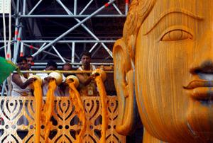 Devotees pour turmeric paste on the statue of Jain god Gomateshwara during a ceremony, Shravanabelagola, February 17(REUTERS) Devotees pour turmeric paste on the statue of Jain god Gomateshwara during a ceremony, Shravanabelagola, February 17(REUTERS)
