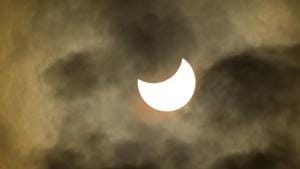 A partial solar eclipse takes place when the earth moves through the lunar penumbra as the moon travels between the earth and the sun. This is the partial solar eclipse viewed under cloudy skies from Arizona on August 21, 2017.(Shutterstock) A partial solar eclipse takes place when the earth moves through the lunar penumbra as the moon travels between the earth and the sun. This is the partial solar eclipse viewed under cloudy skies from Arizona on August 21, 2017.(Shutterstock)