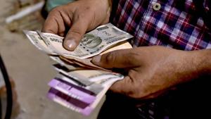 The rupee on Tuesday breached the historic low of 70-mark against the US dollar before recovering at close on suspected RBI intervention and the finance ministry's dismissing the concerns over its sharp fall.(PTI File Photo) The rupee on Tuesday breached the historic low of 70-mark against the US dollar before recovering at close on suspected RBI intervention and the finance ministry's dismissing the concerns over its sharp fall.(PTI File Photo)