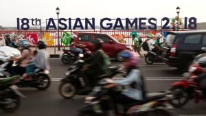 Commuters pass an Asian Games sign on the Ampera Bridge in Palembang, Indonesia.(REUTERS) Commuters pass an Asian Games sign on the Ampera Bridge in Palembang, Indonesia.(REUTERS)