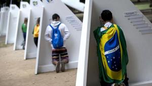 Catholics kneel at portable confessionals set up in Quinta da Boa Vista park during World Youth Day events in Rio de Janeiro, Brazil, earlier this year.(AP File) Catholics kneel at portable confessionals set up in Quinta da Boa Vista park during World Youth Day events in Rio de Janeiro, Brazil, earlier this year.(AP File)
