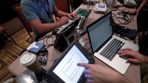 Hackers try to access and alter data from an electronic poll books in a Voting Machine Hacking Village during the Def Con hacker convention in Las Vegas, Nevada, US.(REUTERS File Photo) Hackers try to access and alter data from an electronic poll books in a Voting Machine Hacking Village during the Def Con hacker convention in Las Vegas, Nevada, US.(REUTERS File Photo)