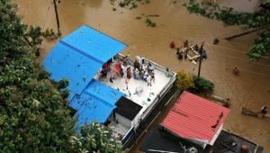 People wait for aid on the roof of their house at a flooded area in Kerala, August 17, 2018. REUTERS/Sivaram V(Reuters) People wait for aid on the roof of their house at a flooded area in Kerala, August 17, 2018. REUTERS/Sivaram V(Reuters)