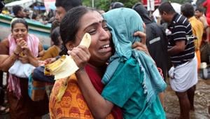 A woman cries as she holds her son after they were evacuated from a flooded area in Aluva in Kerala, on August 18, 2018.(Reuters) A woman cries as she holds her son after they were evacuated from a flooded area in Aluva in Kerala, on August 18, 2018.(Reuters)