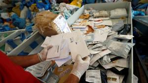 A Palestinian worker displays items sent by mail eight years ago as they reach destination, after Israel allowed the letters and goods into the West Bank from Jordan, where they were being held, Jericho, in the occupied West Bank on August 19.(REUTERS) A Palestinian worker displays items sent by mail eight years ago as they reach destination, after Israel allowed the letters and goods into the West Bank from Jordan, where they were being held, Jericho, in the occupied West Bank on August 19.(REUTERS)